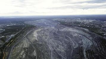 Coal mining at an open pit. Top view of the quarry. Dozers and trucks at buildings site on top aerial view photo