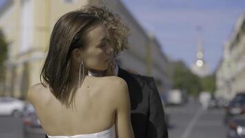 Wedding photography. Action. A beautiful couple of newlyweds in summer-style wedding suits pose with love photo