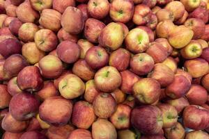 full-frame view of unadorned pile of red apples in a grocery store photo
