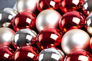 Christmas mirror balls, full frame background of red, silver and white, close-up. photo