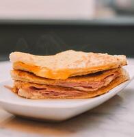 Hot ham and cheese sandwich, toasted with butter on bread photo