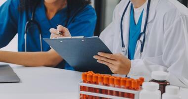 biochemical research scientist team working with microscope for coronavirus vaccine development in pharmaceutical research labolatory, selective focus photo