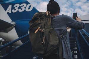 Happy attractive asian woman traveler with backpack at the modern airport terminal, copy space, Tourist journey trip concept photo