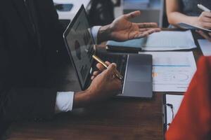 Finance manager meeting discussing company growth project success financial statistics, professional investor working start up project for strategy plan with document, laptop and digital tablet. photo