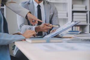 Finance manager meeting discussing company growth project success financial statistics, professional investor working start up project for strategy plan with document, laptop and digital tablet. photo