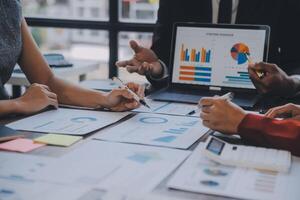 Finance manager meeting discussing company growth project success financial statistics, professional investor working start up project for strategy plan with document, laptop and digital tablet. photo