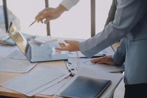 Finance manager meeting discussing company growth project success financial statistics, professional investor working start up project for strategy plan with document, laptop and digital tablet. photo