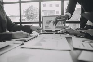 Finance manager meeting discussing company growth project success financial statistics, professional investor working start up project for strategy plan with document, laptop and digital tablet. photo