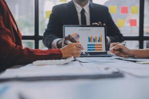 Finance manager meeting discussing company growth project success financial statistics, professional investor working start up project for strategy plan with document, laptop and digital tablet. photo