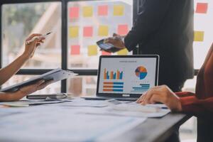 Finance manager meeting discussing company growth project success financial statistics, professional investor working start up project for strategy plan with document, laptop and digital tablet. photo