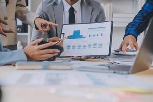 Finance manager meeting discussing company growth project success financial statistics, professional investor working start up project for strategy plan with document, laptop and digital tablet. photo