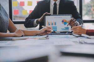 Finance manager meeting discussing company growth project success financial statistics, professional investor working start up project for strategy plan with document, laptop and digital tablet. photo
