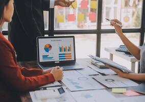 Finance manager meeting discussing company growth project success financial statistics, professional investor working start up project for strategy plan with document, laptop and digital tablet. photo