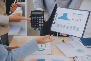Finance manager meeting discussing company growth project success financial statistics, professional investor working start up project for strategy plan with document, laptop and digital tablet. photo