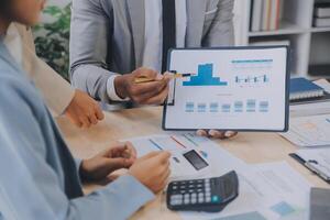 Finance manager meeting discussing company growth project success financial statistics, professional investor working start up project for strategy plan with document, laptop and digital tablet. photo