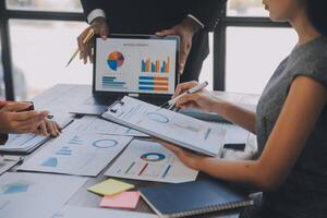 Finance manager meeting discussing company growth project success financial statistics, professional investor working start up project for strategy plan with document, laptop and digital tablet. photo