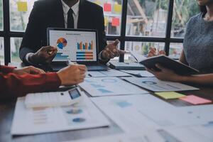 Finance manager meeting discussing company growth project success financial statistics, professional investor working start up project for strategy plan with document, laptop and digital tablet. photo