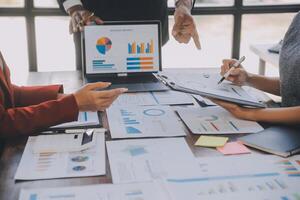 Finance manager meeting discussing company growth project success financial statistics, professional investor working start up project for strategy plan with document, laptop and digital tablet. photo