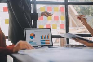 Finance manager meeting discussing company growth project success financial statistics, professional investor working start up project for strategy plan with document, laptop and digital tablet. photo