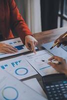 Finance manager meeting discussing company growth project success financial statistics, professional investor working start up project for strategy plan with document, laptop and digital tablet. photo