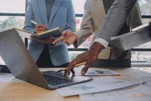 Finance manager meeting discussing company growth project success financial statistics, professional investor working start up project for strategy plan with document, laptop and digital tablet. photo