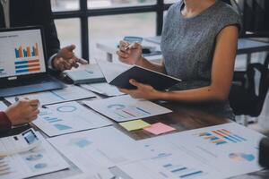 Finance manager meeting discussing company growth project success financial statistics, professional investor working start up project for strategy plan with document, laptop and digital tablet. photo