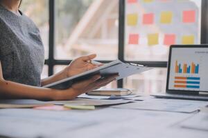 Finance manager meeting discussing company growth project success financial statistics, professional investor working start up project for strategy plan with document, laptop and digital tablet. photo