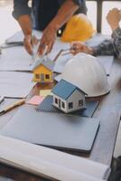 A team of construction engineers talks to managers and construction workers at the construction site. Quality inspection, work plan, home and industrial building design project photo