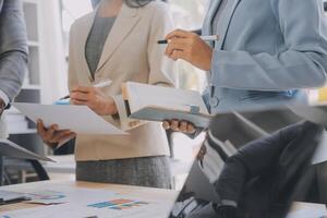 Finance manager meeting discussing company growth project success financial statistics, professional investor working start up project for strategy plan with document, laptop and digital tablet. photo