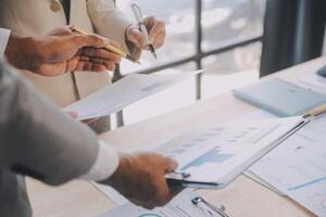 Finance manager meeting discussing company growth project success financial statistics, professional investor working start up project for strategy plan with document, laptop and digital tablet. photo