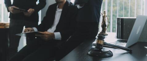 Group of experienced attorneys and lawyers giving consultation to client, helping with difficult lawsuit, explaining legal procedures and discussing agreement terms. Law services and support concept photo
