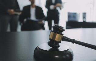 Group of experienced attorneys and lawyers giving consultation to client, helping with difficult lawsuit, explaining legal procedures and discussing agreement terms. Law services and support concept photo