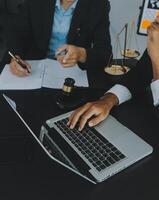 Group of experienced attorneys and lawyers giving consultation to client, helping with difficult lawsuit, explaining legal procedures and discussing agreement terms. Law services and support concept photo