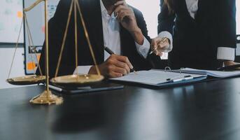 Group of experienced attorneys and lawyers giving consultation to client, helping with difficult lawsuit, explaining legal procedures and discussing agreement terms. Law services and support concept photo