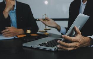 Group of experienced attorneys and lawyers giving consultation to client, helping with difficult lawsuit, explaining legal procedures and discussing agreement terms. Law services and support concept photo