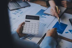 Co working conference, Business team meeting present, investor colleagues discussing new plan financial graph data on office table with laptop and digital tablet, Finance, accounting, investment. photo