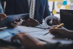 Co working conference, Business team meeting present, investor colleagues discussing new plan financial graph data on office table with laptop and digital tablet, Finance, accounting, investment. photo