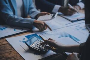 Co working conference, Business team meeting present, investor colleagues discussing new plan financial graph data on office table with laptop and digital tablet, Finance, accounting, investment. photo