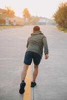 Athlete runner feet running on road photo