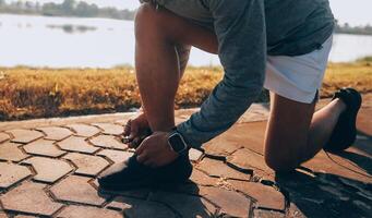 Athlete runner feet running on road photo