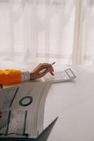 Cropped image of young asian businesswoman working on laptop computer at office. Business lifestyle, successful business concept. photo