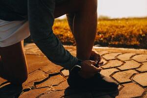 Athlete runner feet running on road,Jogging concept at outdoors. Man running for exercise.Athlete runner feet running on road, Jogging concept at outdoors. Man running for exercise. photo