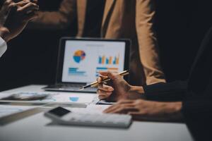 Financial analysts analyze business financial reports on a digital tablet planning investment project during a discussion at a meeting of corporate showing the results of their successful teamwork. photo