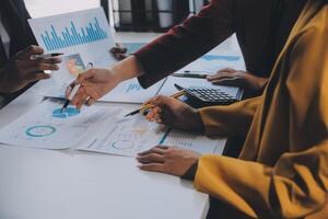 Financial analysts analyze business financial reports on a digital tablet planning investment project during a discussion at a meeting of corporate showing the results of their successful teamwork. photo