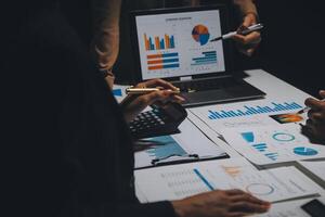 Financial analysts analyze business financial reports on a digital tablet planning investment project during a discussion at a meeting of corporate showing the results of their successful teamwork. photo