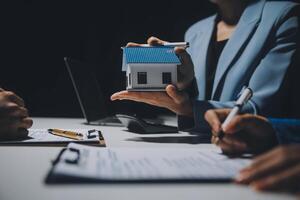 Real estate agent and customer signing contract to buy house, insurance or loan real estate.rent a house,get insurance or loan real estate or property. photo