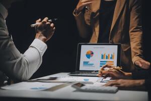 Financial analysts analyze business financial reports on a digital tablet planning investment project during a discussion at a meeting of corporate showing the results of their successful teamwork. photo