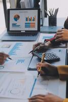 Financial analysts analyze business financial reports on a digital tablet planning investment project during a discussion at a meeting of corporate showing the results of their successful teamwork. photo