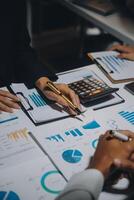 Financial analysts analyze business financial reports on a digital tablet planning investment project during a discussion at a meeting of corporate showing the results of their successful teamwork. photo