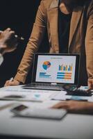 Financial analysts analyze business financial reports on a digital tablet planning investment project during a discussion at a meeting of corporate showing the results of their successful teamwork. photo